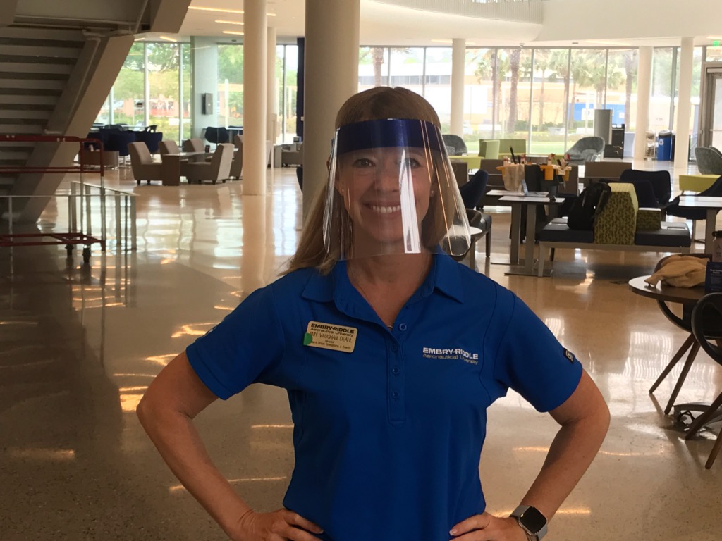 Amy Vaughn Deahl, director of student union operations and events, models a face shield manufactured by students on Embry-Riddle’s Daytona Beach Campus.
