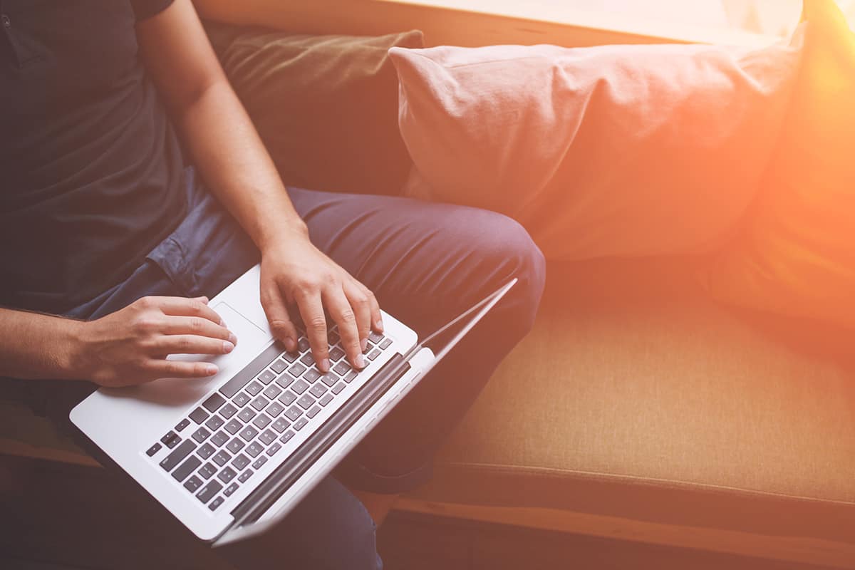 a man on the couch with a laptop