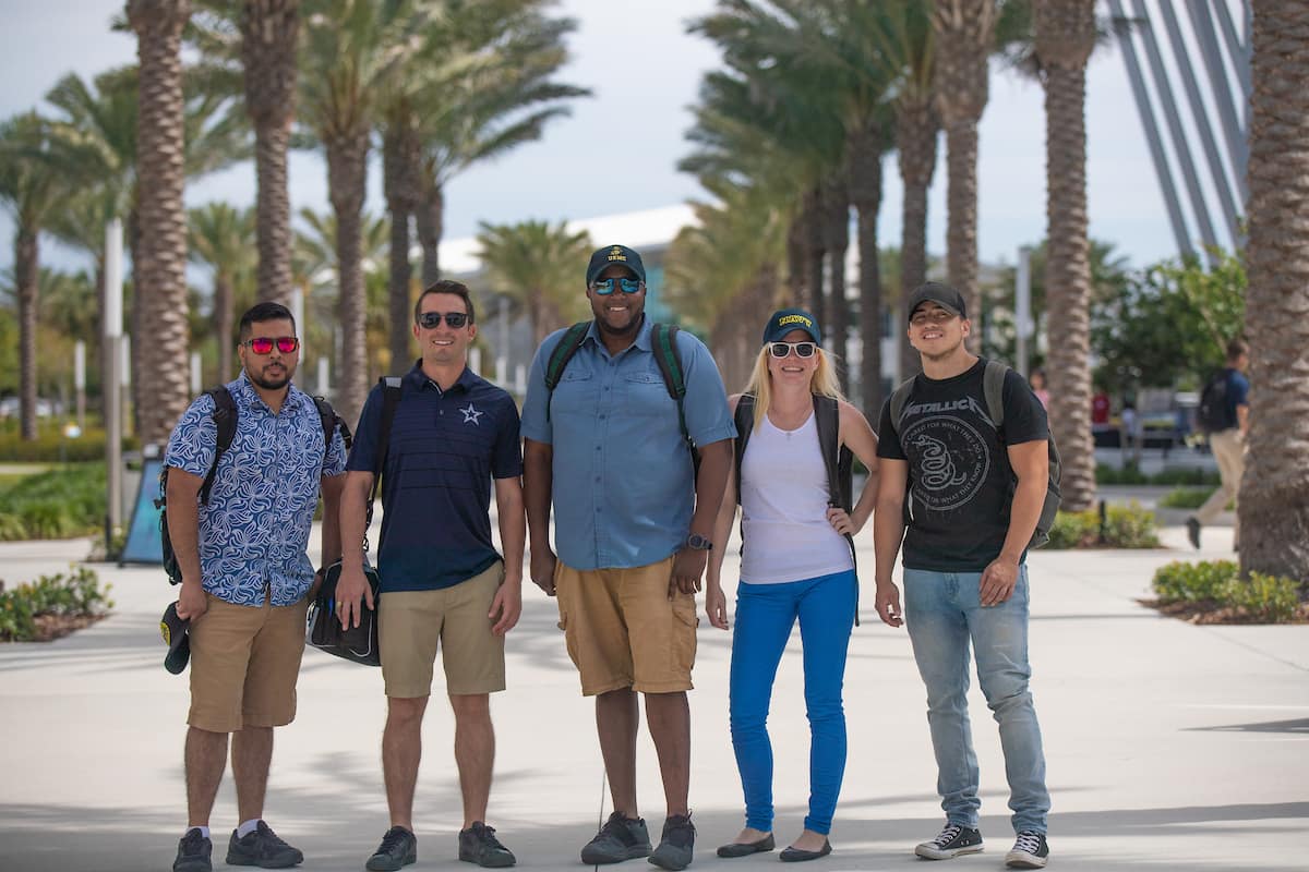 Veteran-students Jose Acosta, United States Army; Brandon Baber, United States Marine Corps (USMC); Michael Janvier, USMC; Rebecca Pernini, United States Navy; and Jaan Jimenez, USMC, convene on Embry-Riddle’s Daytona Beach Campus. (Photo: Embry-Riddle/David Massey)