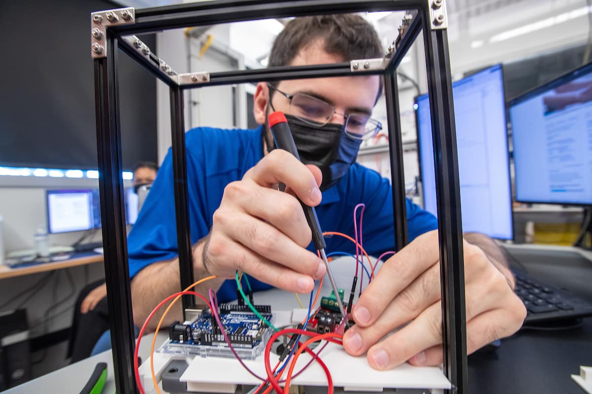 Embry-Riddle graduate student Jonathon G. Nadeau tweaks a part on a prototype based on a concept from Michael Dupuis of NASA’s Kennedy Space Center that would leverage solar propulsion to clean up space debris. (Photo: Embry-Riddle/David Massey) 