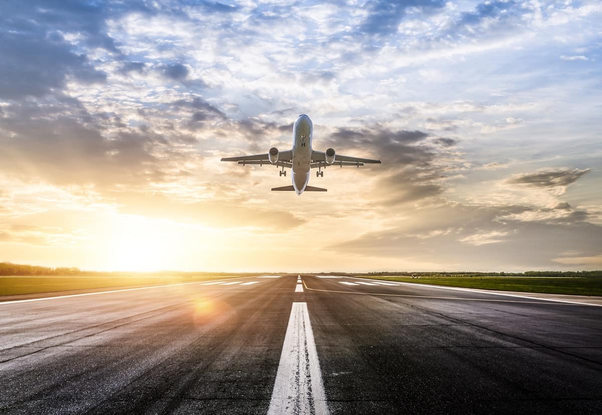 Plane taking off at sunrise.