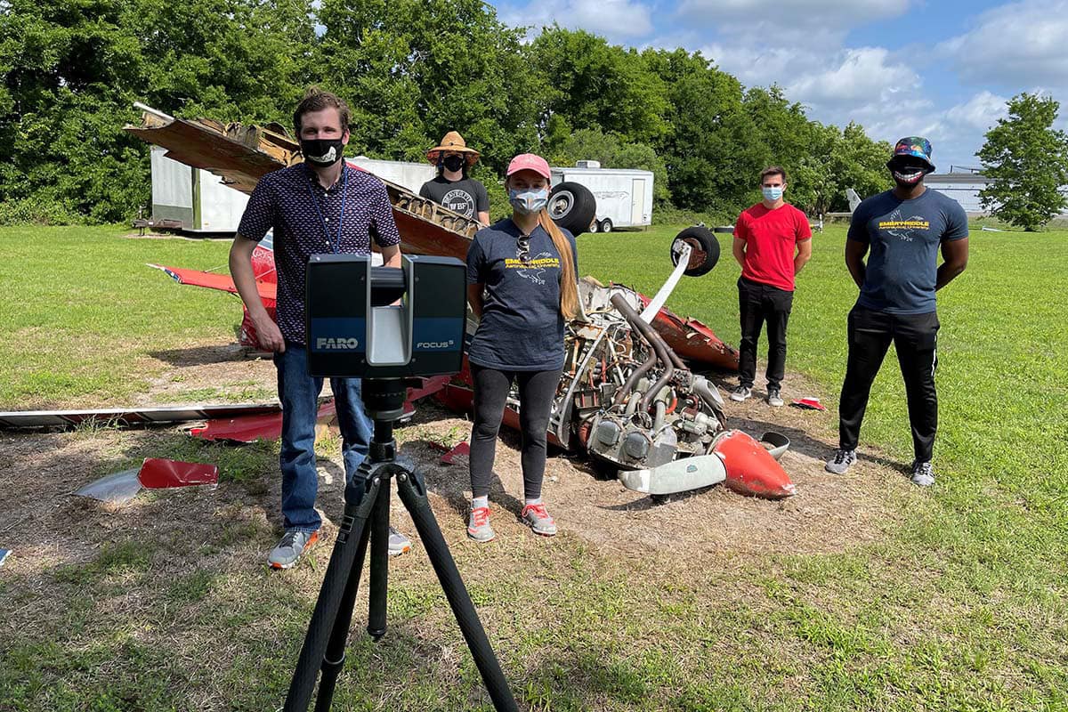 Applied Aviation Sciences students Schyler Sapinski, Sydney Pilling, Dharaj Samuel, Marcin Makowski and Donald Ventrice analyze wreckage at Embry-Riddle’s Aerospace Forensics Lab, using the university’s new 3D-modeling scanner. (Photos: Anthony Brickhouse)