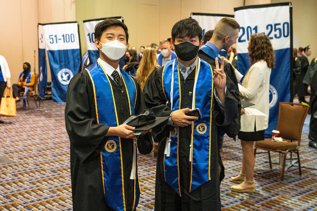 Two ERAU graduates at commencement.