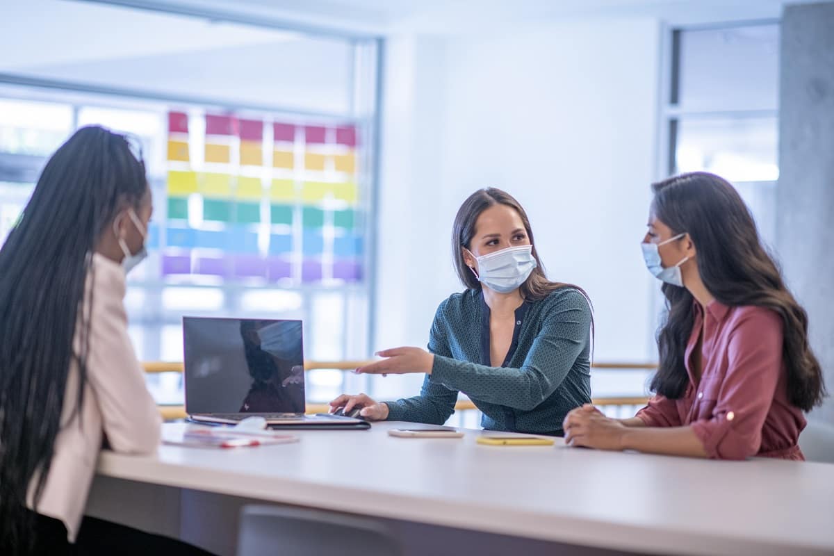 Students wear masks during a meeting.