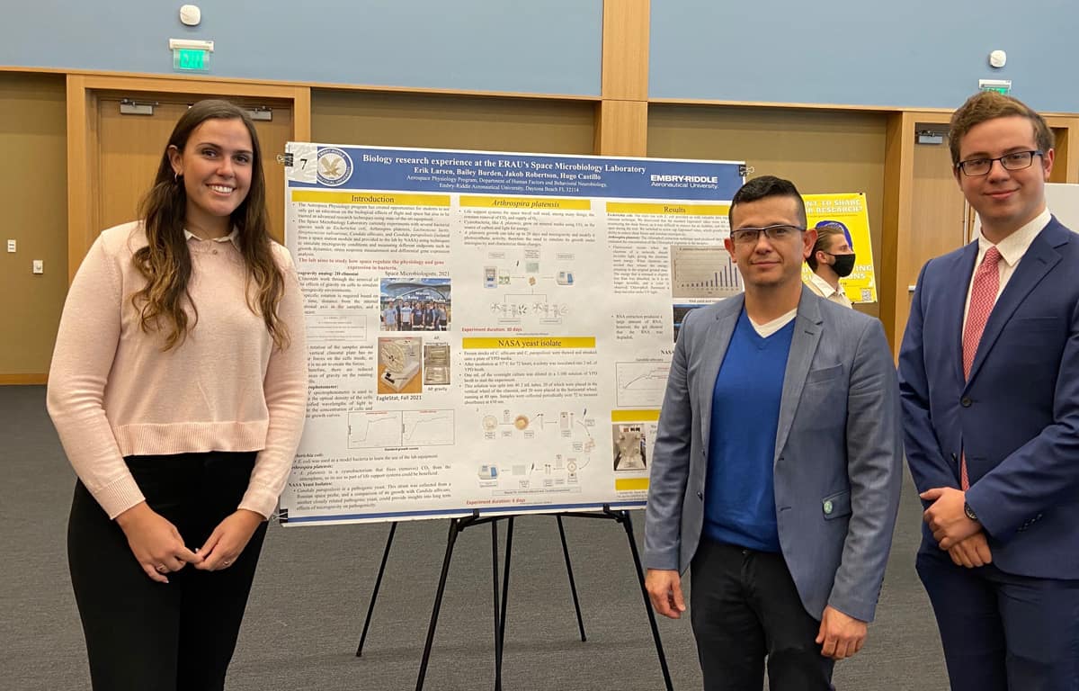 Senior researcher Bailey Burden, assistant professor Hugo Castillo and senior researcher Erik Larsen pose at the 2021 Student Research Symposium. 