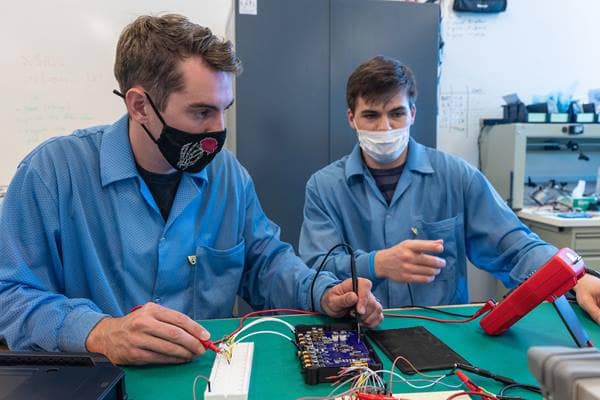 Embry-Riddle Ph.D. candidates Henry Valentine and Nathan Graves work on circuit boards that they hope will one day run equipment on Mars in the Space and Atmospheric Instrumentation Lab (SAIL). (Photo: Embry-Riddle/Daryl LaBello)