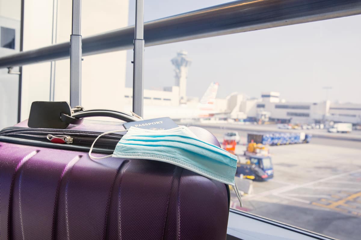 Mask and passport at an airport