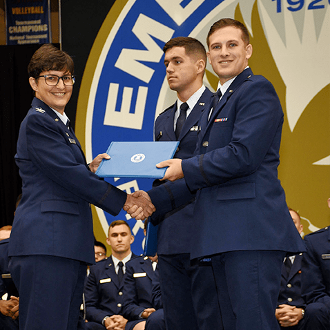 Col. Kimberley Ramos, left, at the AFROTC Commissioning Ceremony in May. Second Lt. Brandon Koury received distinguished graduate recognition.