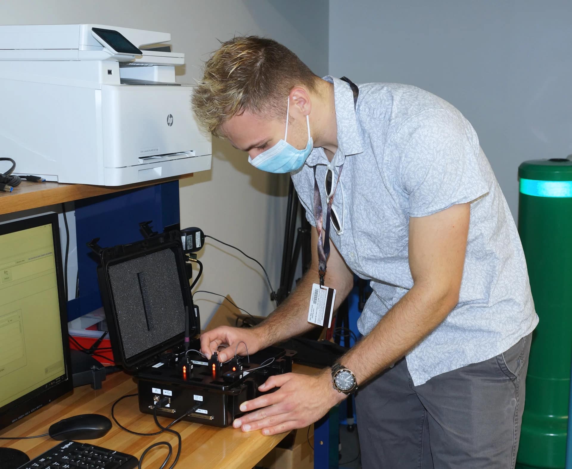 Mechanical Engineering student Riley Flanagan activates wireless electromyograph sensors, a key component of his project to enhance augmented-reality applications through a wearable silent speech interface.