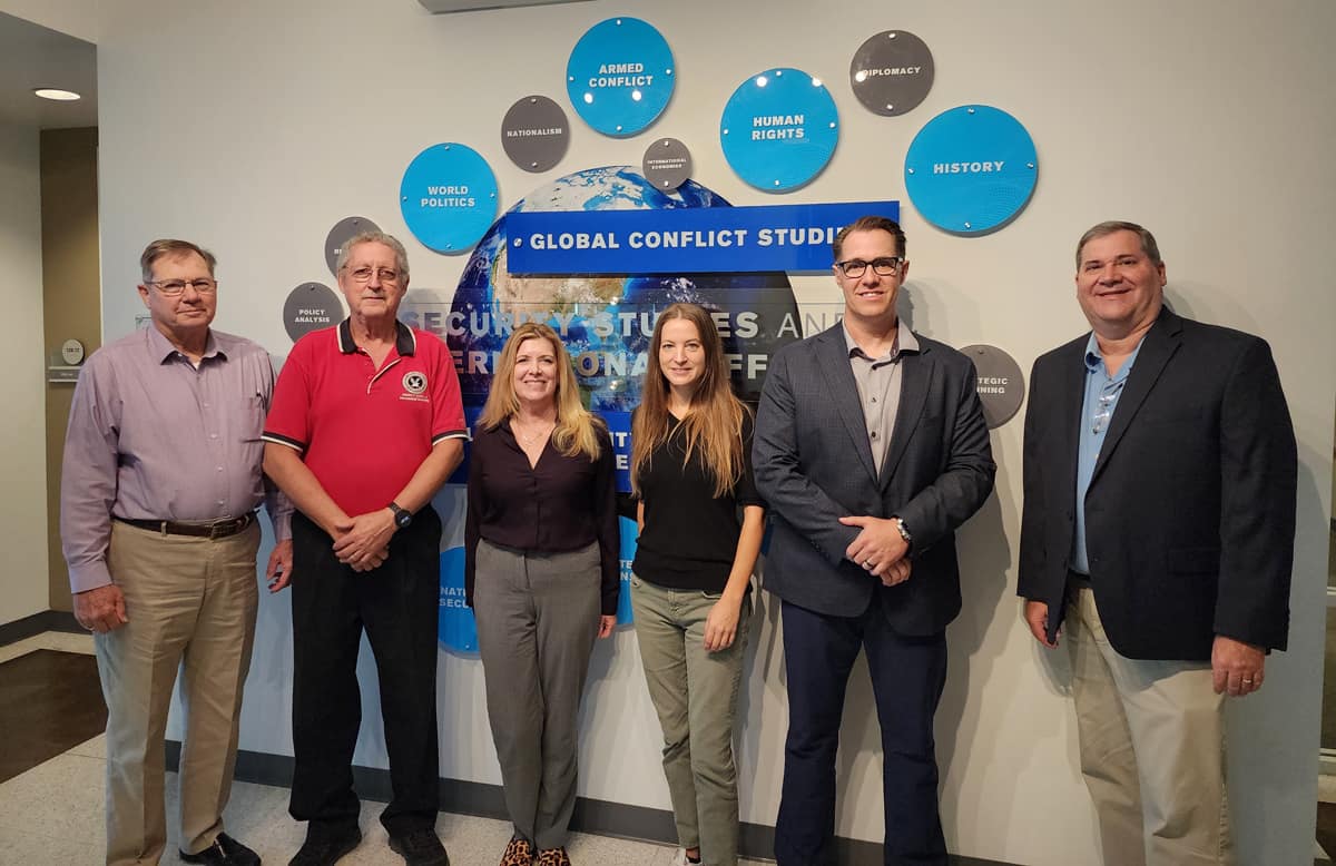 Embry-Riddle faculty join Council for the Accreditation of Emergency Management and Homeland Security Education representatives outside the university’s Department of Security Studies and International Affairs. Pictured from left to right are: Dr. Larry Porter, CAEMHSE president; Dr. Daniel Cutrer, associate professor; Ann Phillips, J.D., associate department chair; Dr. Bethany Swindell, CAEMHSE auditor; Dr. Jamie Gauthier, CAEMHSE auditor; and Dr. Stephen Craft, department chair.